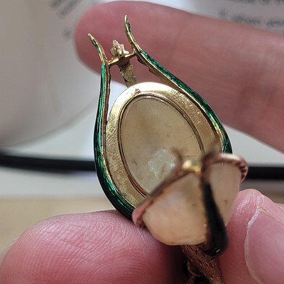 Lot 58 - A mother-of-pearl and enamel locket pendant
