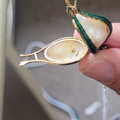 Lot 58 - A mother-of-pearl and enamel locket pendant