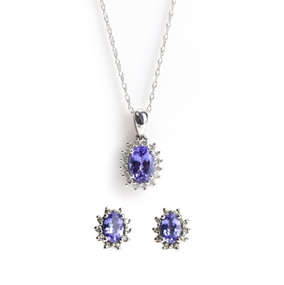 Lot 108 - A tanzanite and diamond pendant and matching 9ct white gold stud earrings