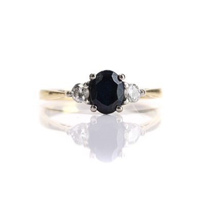 Lot 84 - An 18ct gold sapphire and diamond three stone ring