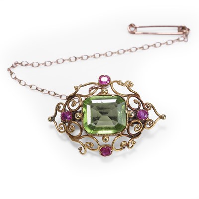 Lot 31 - A peridot and ruby brooch