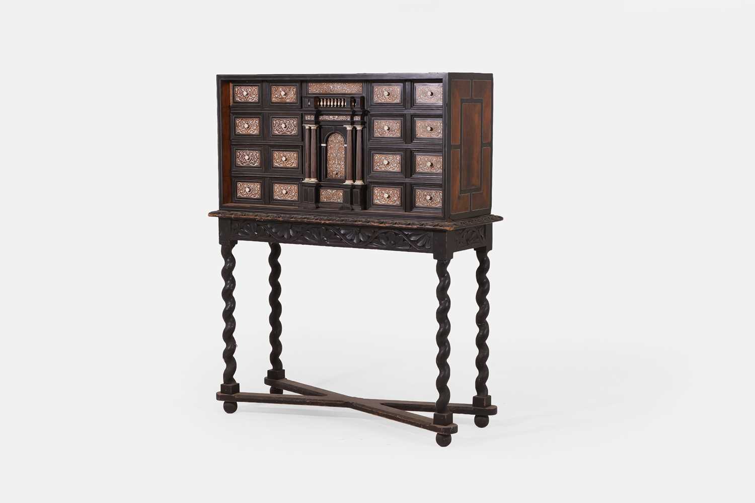 Lot 20 - A baroque ebonised fruitwood, rosewood, ivory and bone cabinet