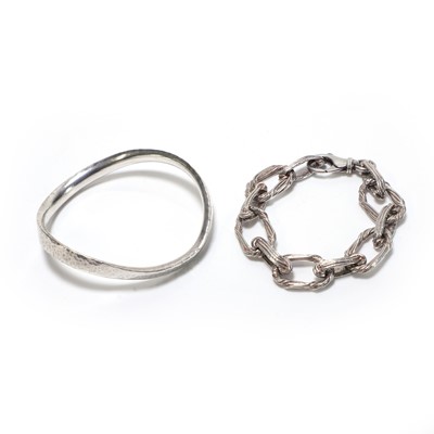 Lot 218 - A silver bangle and a fancy cable link bracelet
