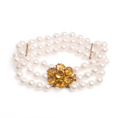 Lot 136 - A three row cultured pearl and citrine bracelet