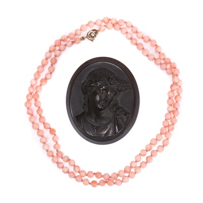 Lot 249 - A pink coral bead necklace and a cameo brooch