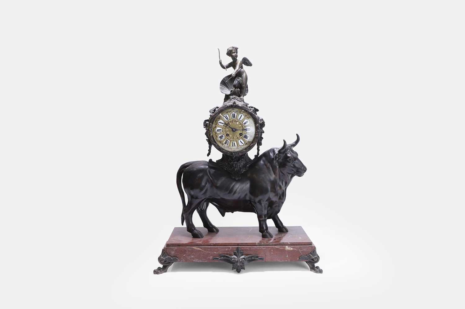 Lot 12 - A Louis XV-style patinated bronze mantel clock