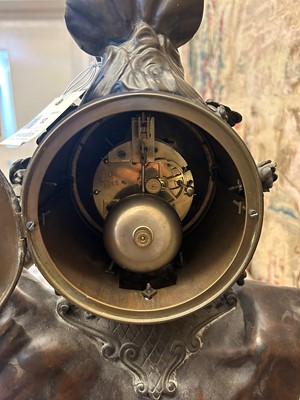Lot 12 - A Louis XV-style patinated bronze mantel clock