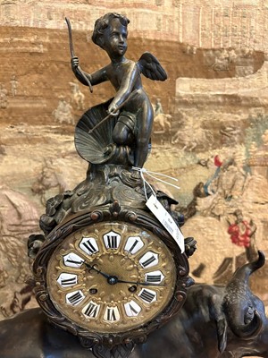 Lot 12 - A Louis XV-style patinated bronze mantel clock