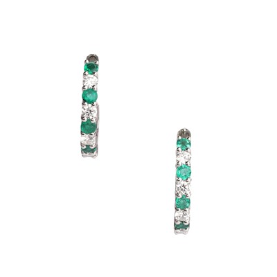 Lot 152 - A pair of 18ct white gold emerald and diamond hoop earrings