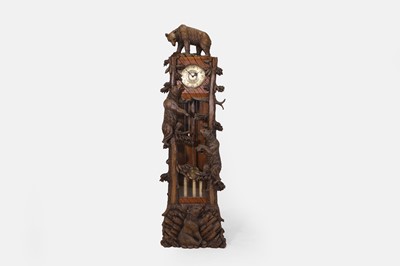 Lot 196 - A Black Forest carved wooden longcase clock
