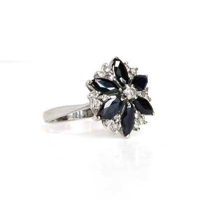 Lot 79 - An 18ct white gold sapphire and diamond cluster ring