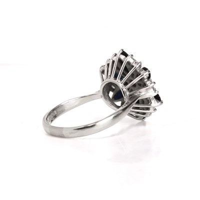 Lot 79 - An 18ct white gold sapphire and diamond cluster ring