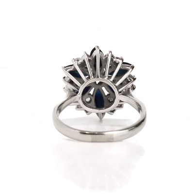 Lot 79 - An 18ct white gold sapphire and diamond cluster ring