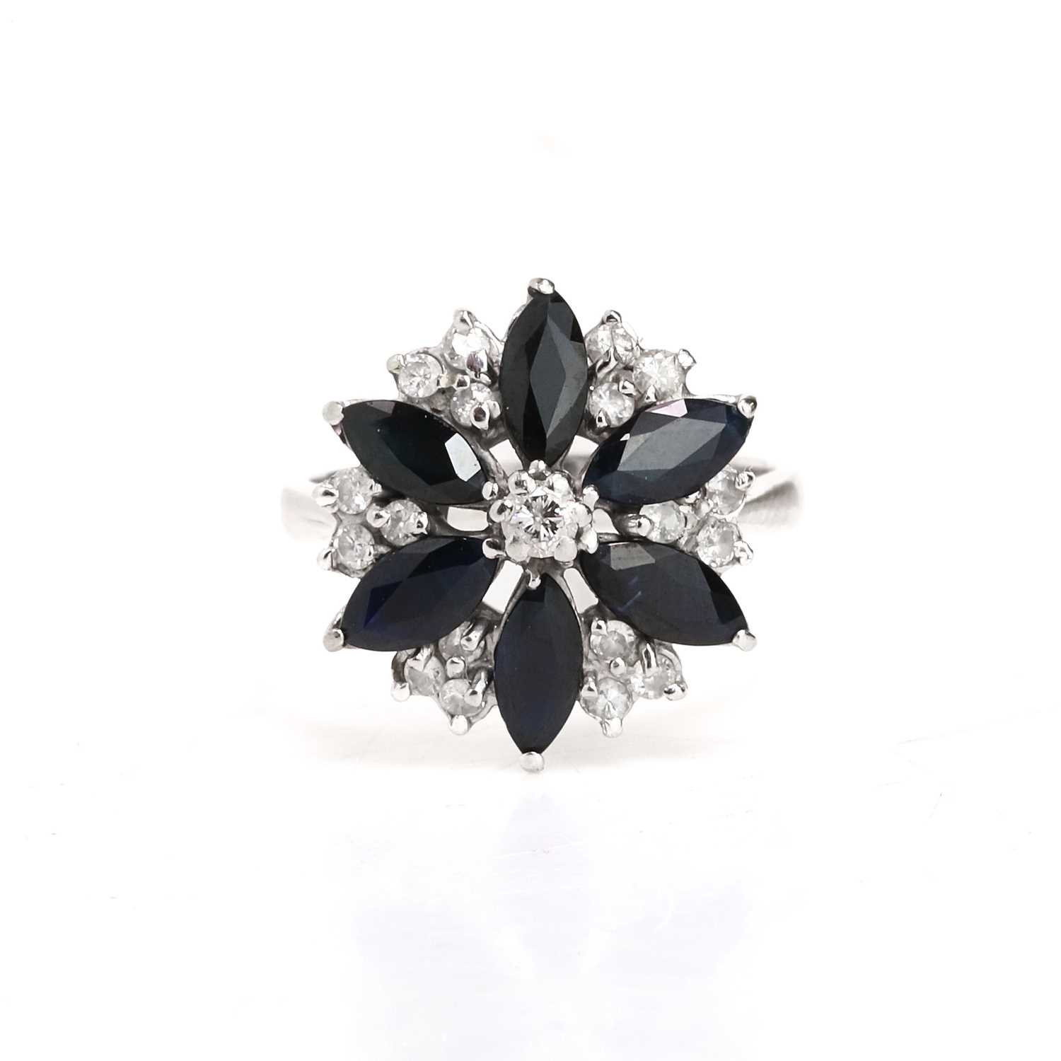 Lot 79 - An 18ct white gold sapphire and diamond cluster ring