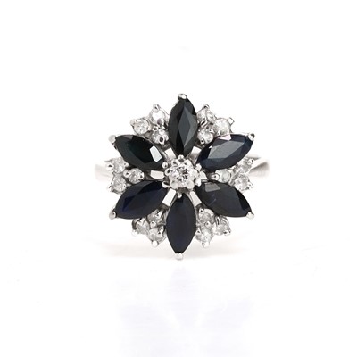 Lot 79 - An 18ct white gold sapphire and diamond cluster ring