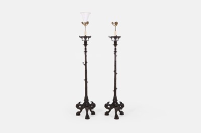 Lot 57 - A pair of patinated bronze floor lamps