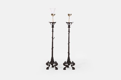 Lot 57 - A pair of patinated bronze floor lamps