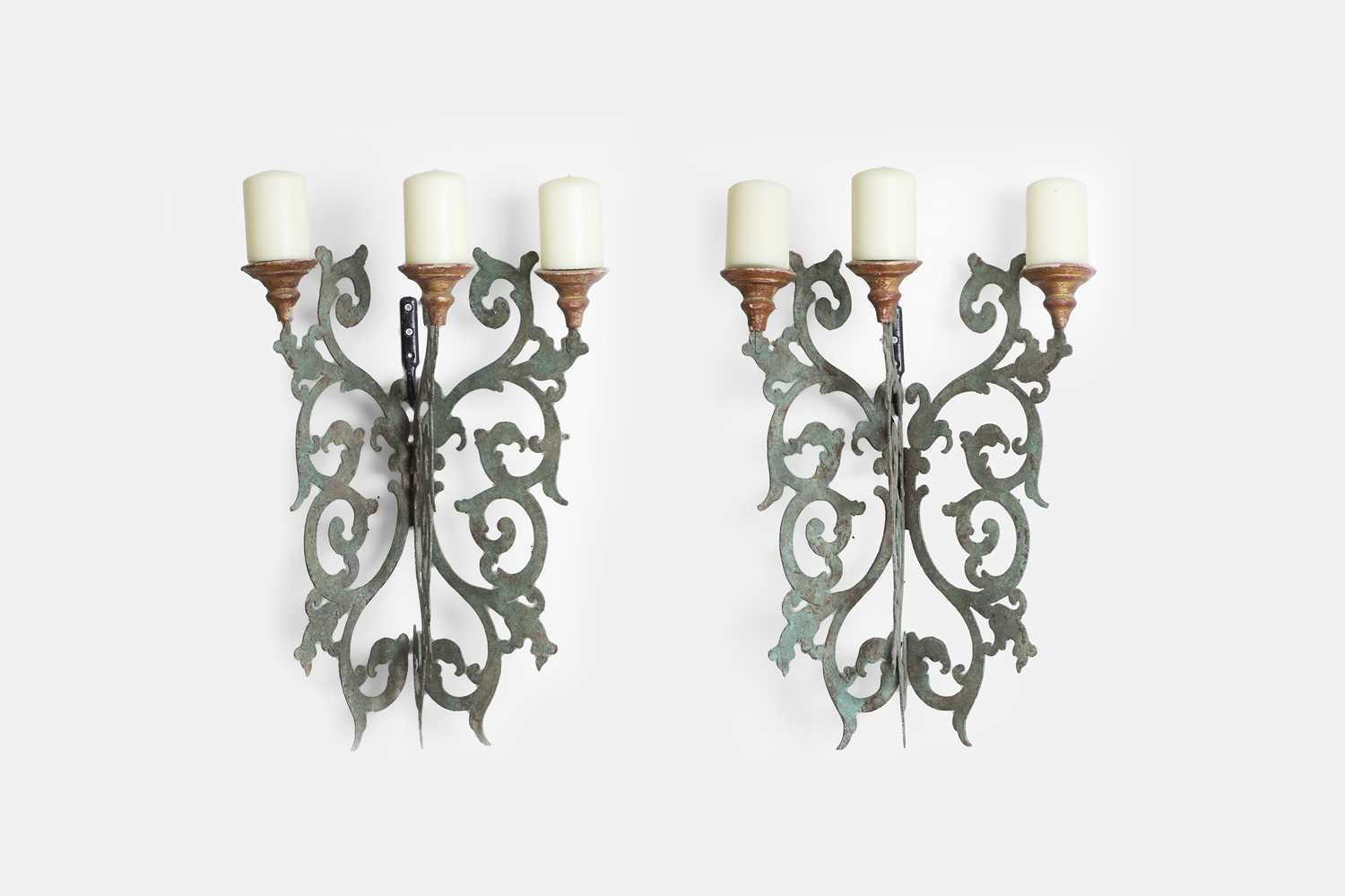 Lot 28 - A pair of patinated pierced-metal wall lights