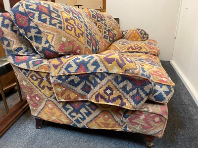 Lot 79 - An upholstered two-seater sofa in the Howard & Sons style