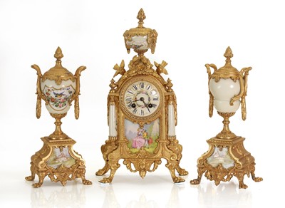 Lot 206 - A French gilt metal clock garniture inset with porcelain panels
