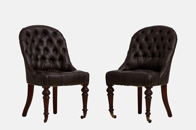 Lot 357 - A pair of mahogany and leather library chairs by Howard & Sons