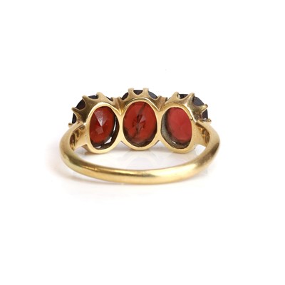 Lot 28 - A late Victorian/Edwardian three stone garnet ring