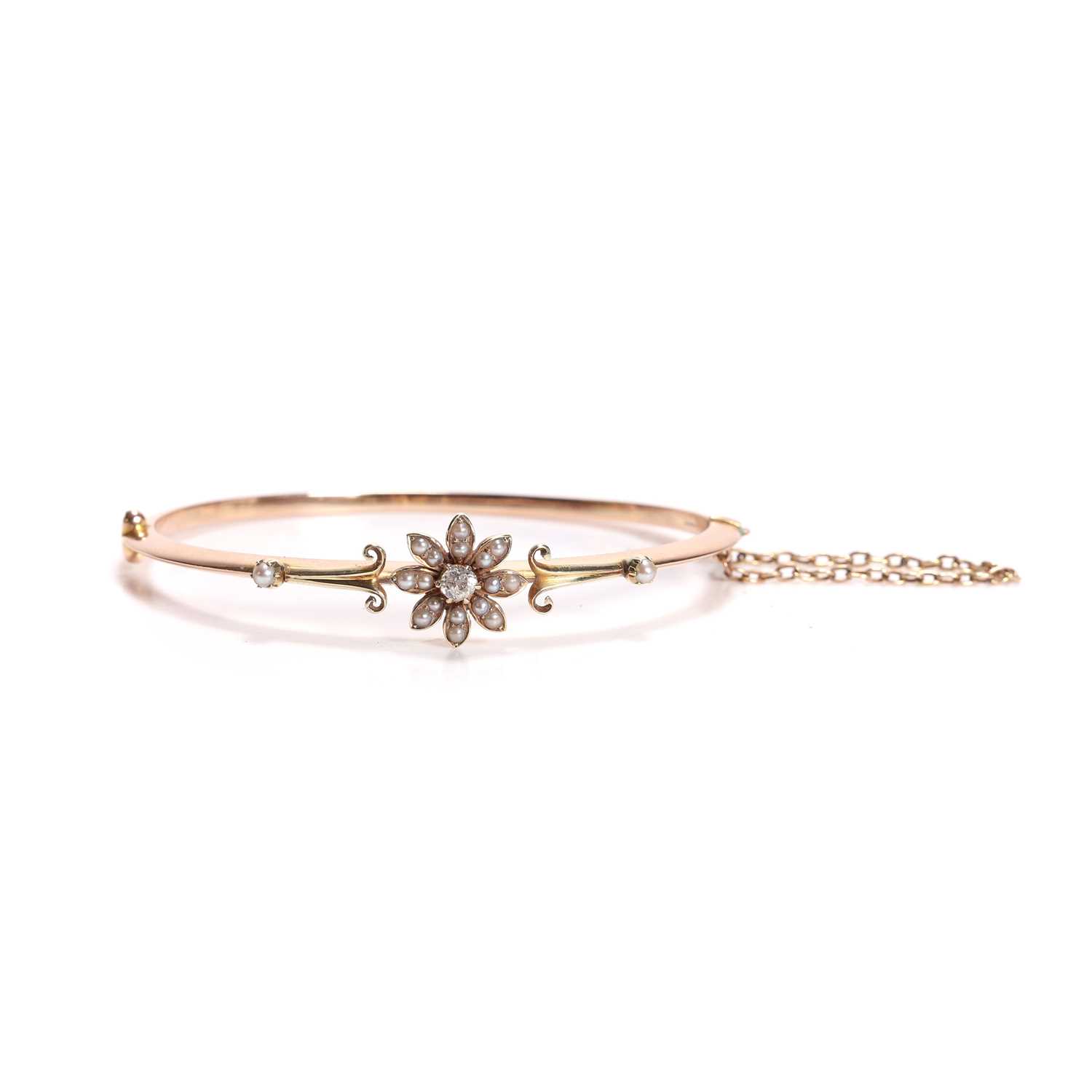 Lot 41 - A diamond and split pearl hinged bangle
