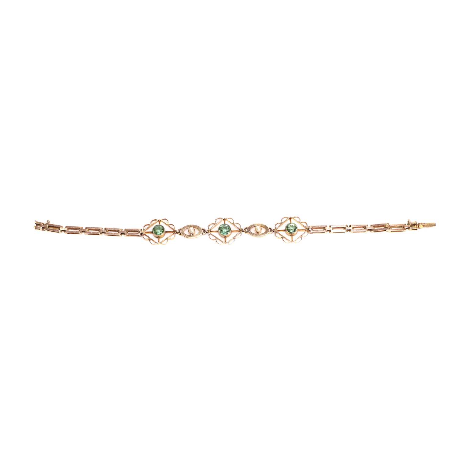 Lot 53 - An Edwardian green tourmaline and split pearl bracelet