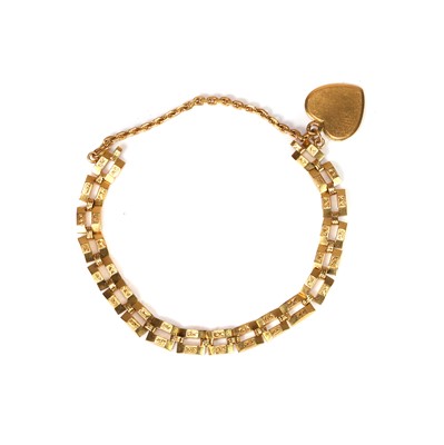 Lot 353 - A gold link bracelet with a heart charm