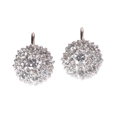 Lot 126 - A pair of diamond daisy cluster earrings