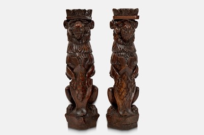 Lot 404 - A pair of hardwood lion monopodia pedestals