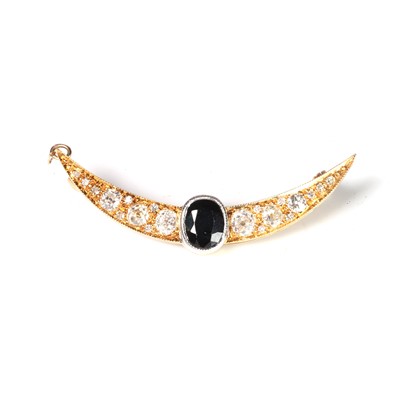 Lot 75 - A diamond and sapphire crescent brooch