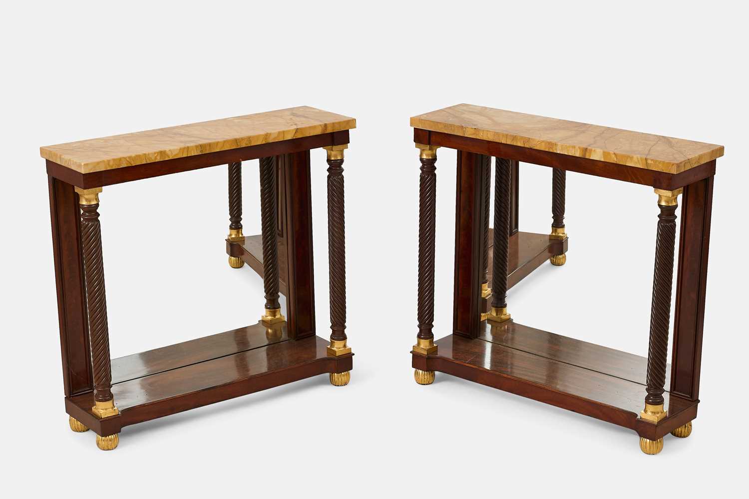 Lot 314 - A pair of Regency-style mahogany and parcel-gilt pier tables