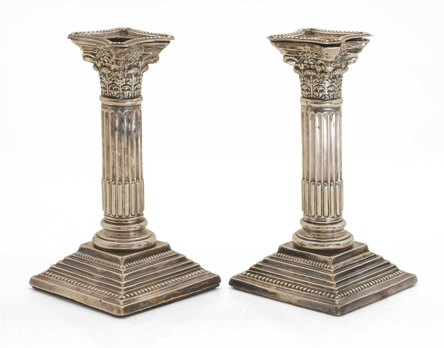 Lot 23 - A pair of Edwardian Corinthian column candlesticks