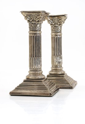 Lot 23 - A pair of Edwardian Corinthian column candlesticks