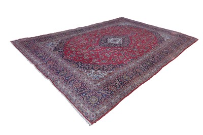 Lot 422 - A large red ground carpet