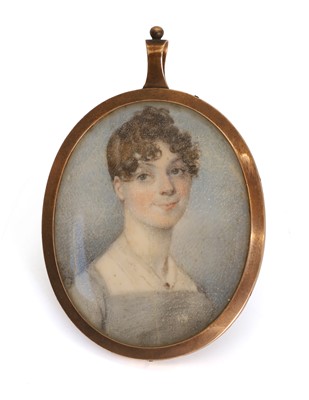 Lot 314 - A portrait miniature pendant of a young woman