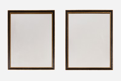 Lot 389 - A pair of ebonised and parcel-gilt wooden wall mirrors