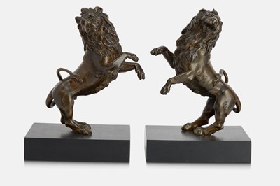Lot 78 - A pair of bronze lion rampant sculptures