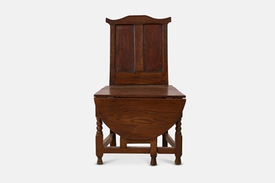 Lot 257 - An oak metamorphic chair table