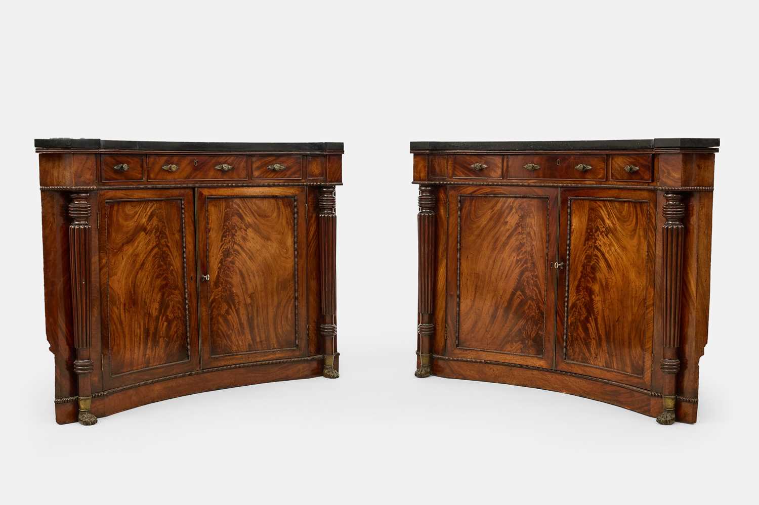 Lot 30 - A pair of Regency mahogany corner cabinets