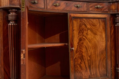 Lot 30 - A pair of Regency mahogany corner cabinets