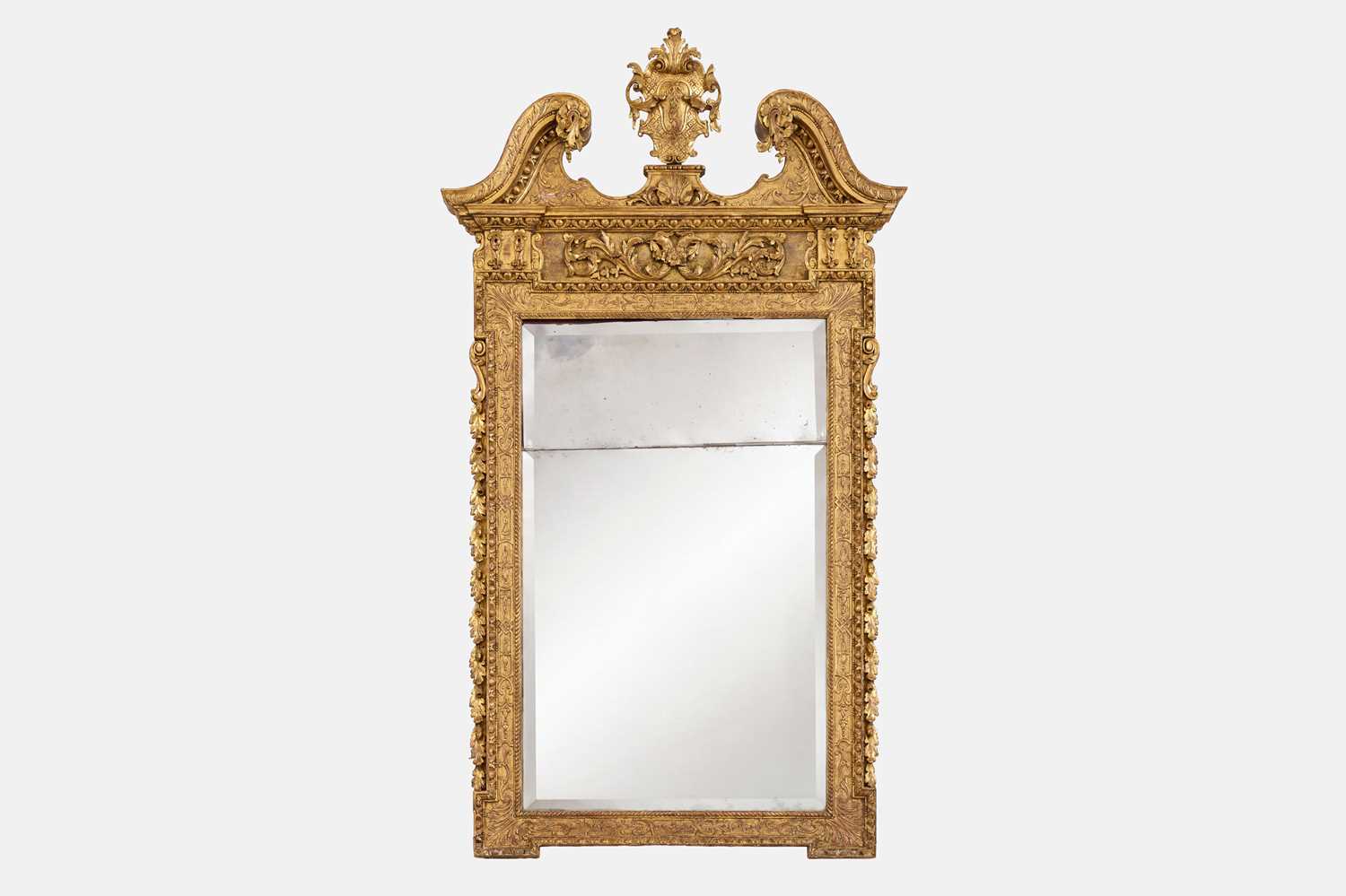 Lot 4 - A George II giltwood and gesso mirror in the manner of William Kent