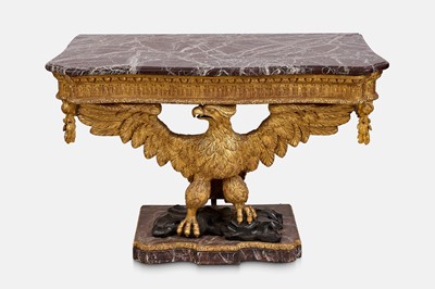 Lot A pair of George II-style carved giltwood eagle console tables