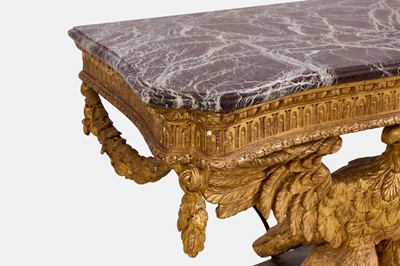 Lot A pair of George II-style carved giltwood eagle console tables
