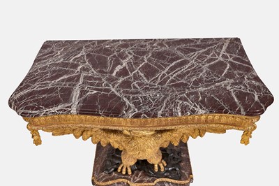 Lot A pair of George II-style carved giltwood eagle console tables