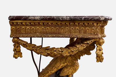 Lot A pair of George II-style carved giltwood eagle console tables
