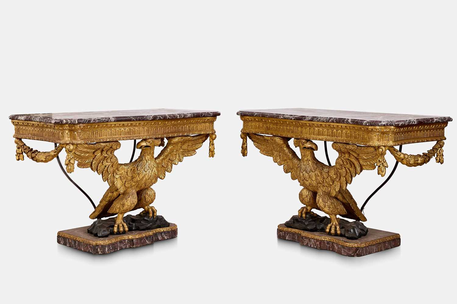 Lot A pair of George II-style carved giltwood eagle console tables