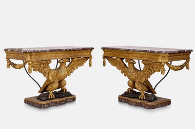 Lot A pair of George II-style carved giltwood eagle console tables
