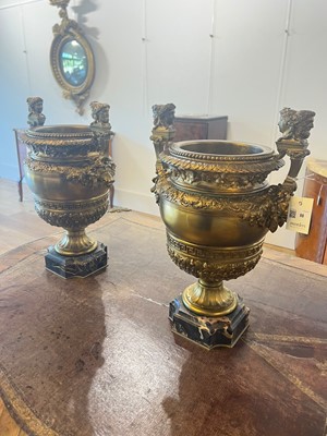 Lot 88 - A pair of neoclassical gilt-bronze urns